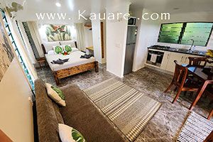 Inside the bungalow showing the Kind bed, kitchen and lounge area